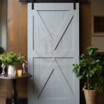 "Traditional barn door hardware accentuates the vintage appeal of this sliding door."